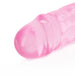 Close-up of the pink translucent tip of a dual-ended dildo with a smooth, rounded design.