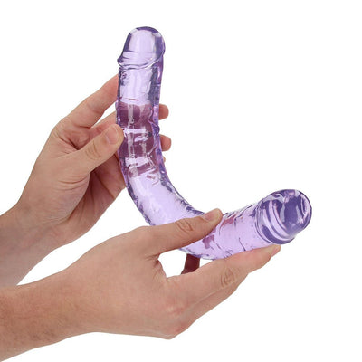 Hands holding a flexible, translucent purple double-ended dildo with realistic texture and shape.