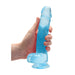 Hand holding a blue crystal clear realistic dildo with balls and suction cup base against white background.