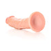 Curved vanilla-colored realistic dildo with suction cup base lying on a white surface.