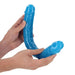 Hands holding a flexible, blue double-ended dildo with realistic texture and glow-in-the-dark material.