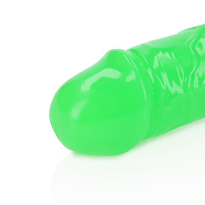 Close-up of neon green glow-in-the-dark dual-ended dildo with smooth, detailed texture.
