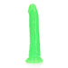 Slim neon green glow-in-the-dark dildo with suction cup base, 7 inches long, textured for enhanced stimulation.