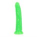Slim neon green glow-in-the-dark dildo with suction cup base, 7 inches long, smooth and textured design.