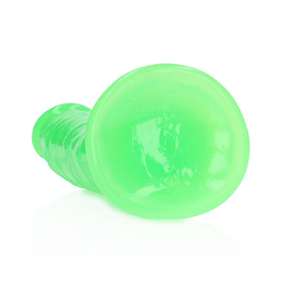Glow in the dark neon green slim dildo with suction cup base, 7 inches long, made of smooth body-safe material.