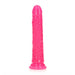 Bright pink slim dildo with textured surface and suction cup base, glow-in-the-dark feature, 7 inches long.