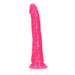 Slim neon pink glow-in-the-dark dildo with suction cup base, 7 inches long, textured for realistic feel.