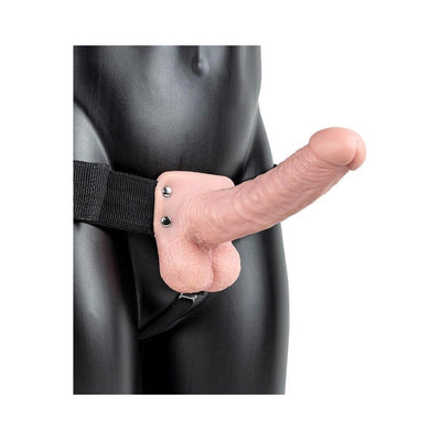 Vanilla-colored hollow strap-on with balls on black mannequin torso, adjustable black waistband visible.