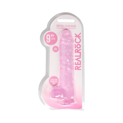 Pink 9-inch realistic dildo with balls and suction cup in clear packaging labeled Realrock, latex and phthalate free.