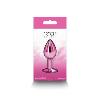 Small pink chrome-plated aluminum anal plug in retail packaging with Rear Assets branding and pink gradient background.