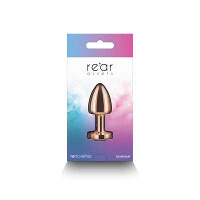 Rose gold petite metal anal plug in colorful gradient packaging labeled Rear Assets by NS Novelties