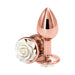 Small rose gold metal butt plug with a white rose detail on the base, polished and reflective surface.