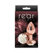 Small rose gold aluminum butt plug with white rose detail on the base, displayed on retail packaging.