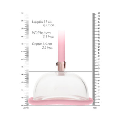 Rechargeable pink pussy pump with clear acrylic cylinder and silicone base shown with measurement scales in cm and inches.