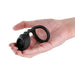 Hand holding a black silicone Renegade Bolster cock ring with dual loops and textured design.