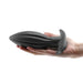 Hand holding a large black silicone Renegade Bomba anal plug with a flared base and textured design.