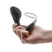 Hand holding the Renegade Slingshot Black, a sleek dual-layer silicone wearable ring and prostate plug.