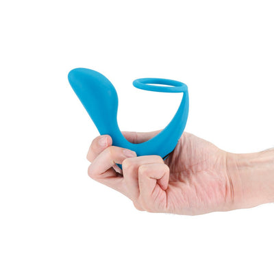 Hand holding a teal silicone dual-stimulation slingshot toy with ergonomic curves and a ring design.