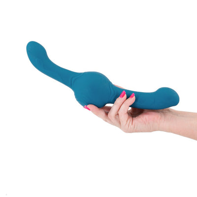 Hand holding a teal flexible dual-ended personal massager with textured design on a white background.