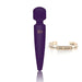Compact purple mini body wand vibrator with gold RS logo and inspirational silver cuff bracelet.