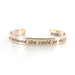 Gold-tone open cuff bracelet with engraved inspirational quote and Rianne S branding inside.