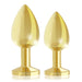 Set of two gold-plated metal butt plugs with tapered tips and flat bases in different sizes.