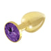 Gold-plated metal butt plug with a faceted purple gem base, smooth and polished finish.