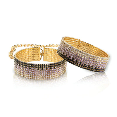 Pair of gold-tone Rianne S Diamond Liz handcuffs with black, white, and purple sparkling stones and chain link detail.