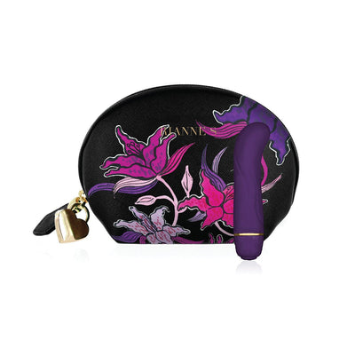 Compact deep purple silicone Mini G vibrator with floral-patterned black cosmetic bag featuring pink and purple flowers and gold heart zipper pull.