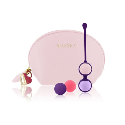 Rianne S Playballs set with silicone holder and three colorful balls displayed in front of a pink cosmetic pouch with gold heart charm.