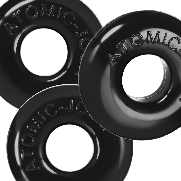 Three black OxBalls Ringer Max stretchy rubber rings with embossed Atomic logo, arranged overlapping on white background.