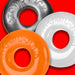 Three colorful OxBalls Ringer Max stretchy rings in black, white, and orange on a red background.