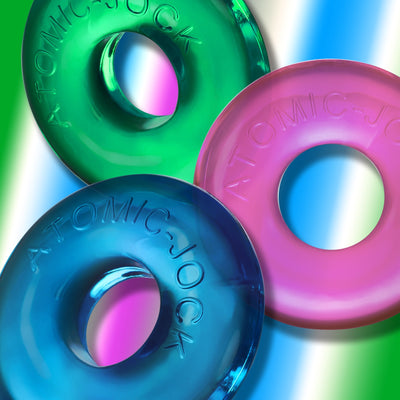 Three translucent OxBalls Ringer Max rings in green, pink, and blue with embossed branding on a colorful background.