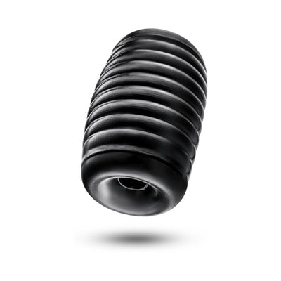 Black ribbed self-lubricating pocket stroker with soft, squeezable texture and dual pleasure chambers.