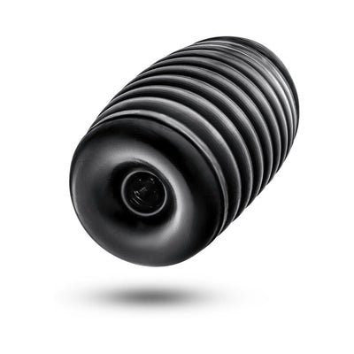 Black ribbed cylindrical self-lubricating stroker with textured grip and central opening.