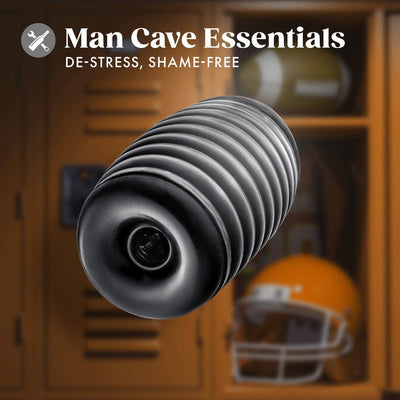 Black ribbed self-lubricating stroker with textured chambers, shown against a blurred locker room background.