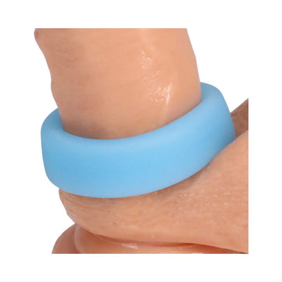 Close-up of a blue glow-in-the-dark silicone ring worn on a finger, showcasing its smooth texture and flexible fit.
