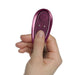 Hand holding a small burgundy remote control for the Rocks Off Knickerbocker Glory pleasure device.