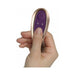Hand holding a small purple and gold remote control for the Rocks Off Petite Sensations Discover Plug.