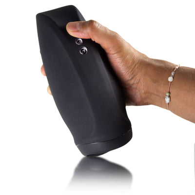 Hand holding a black rechargeable stroker with two control buttons on the side against a white background.
