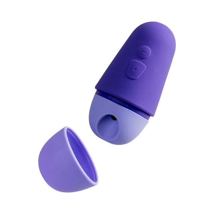 Compact purple silicone personal massager with removable cap and plus/minus control buttons on top.