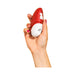 Hand holding the ROMP Free clitoral stimulator in poppy red and white with a smooth, ergonomic design.