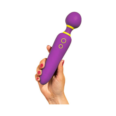 Hand holding a purple ROMP Flip wand massager with yellow accents and two control buttons on a white background.