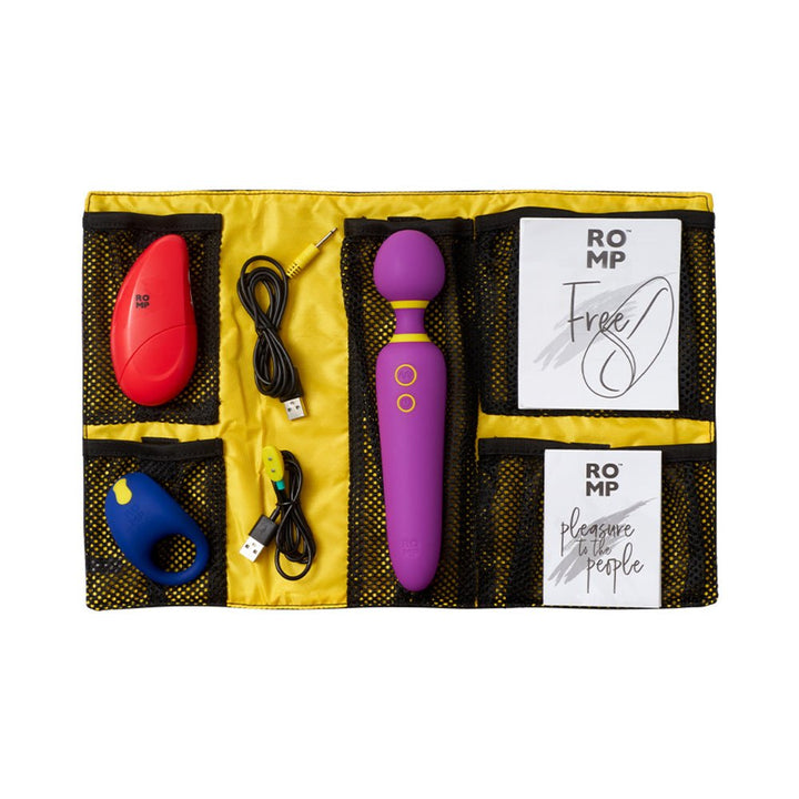 ROMP Pleasure Kit with three vibrators in a yellow roll-up bag, including a purple wand, red stimulator, blue ring, two USB cables, and manuals.