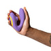 Hand holding a purple ROMP Reverb dual stimulator with yellow accent, designed for G-spot and clitoral stimulation.