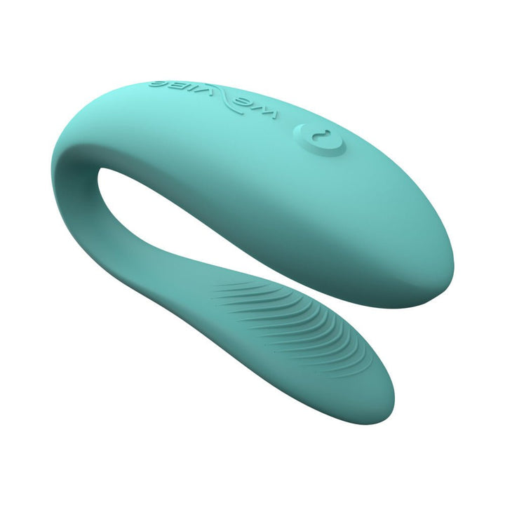 Teal We-Vibe Sync Lite couples vibrator with smooth silicone finish and single-button control on a white background.