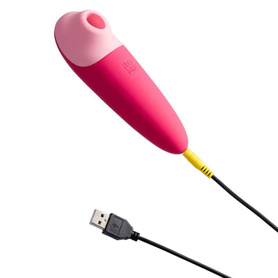 Pink ROMP Shine X silicone personal massager with USB charging cable on white background