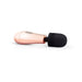 Compact rosy gold mini massager with a soft black silicone head and ergonomic handle, ideal for travel and personal use.