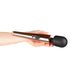 Hand holding a sleek rosy gold wand massager with a black flexible head and control buttons on the handle.