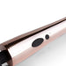 Close-up of the rosy gold wand massager handle showing power and vibration control buttons.